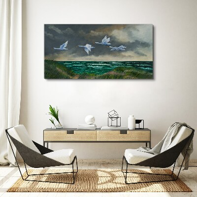Bild auf leinwand Flug der Schwäne über dem Meer