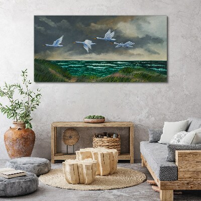 Bild auf leinwand Flug der Schwäne über dem Meer