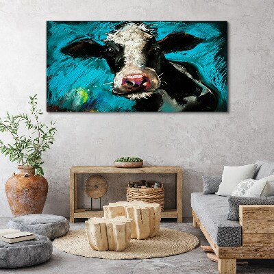 Foto auf leinwand Porträt einer Kuh auf blauem Hintergrund