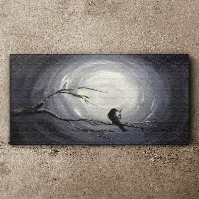 Leinwandbild Ein einsamer Vogel auf einem Ast