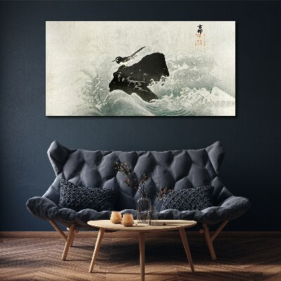 Foto auf leinwand Ein Vogel auf einem Felsen in den Wellen