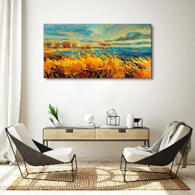 Foto auf leinwand Goldenes Gras über blauem Wasser