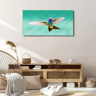 Leinwandbild Kolibri auf blauem Hintergrund