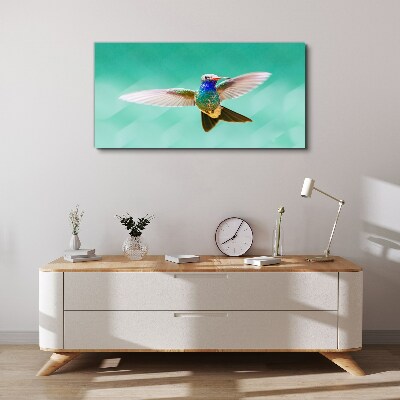 Leinwandbild Kolibri auf blauem Hintergrund