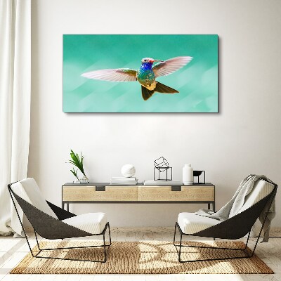 Leinwandbild Kolibri auf blauem Hintergrund