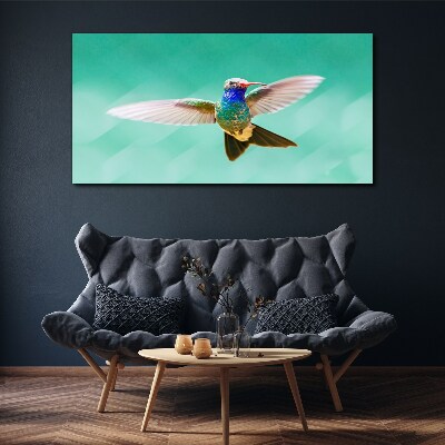 Leinwandbild Kolibri auf blauem Hintergrund