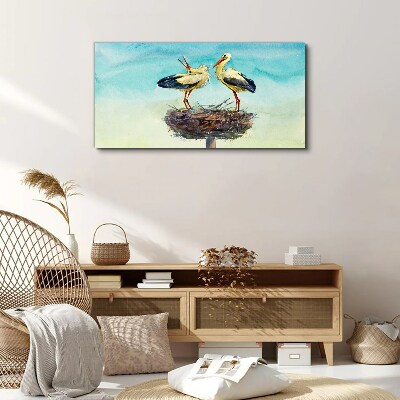 Foto auf leinwand Störche auf einem Nest im Blau