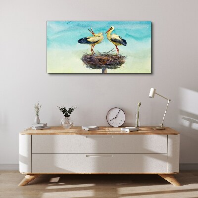 Foto auf leinwand Störche auf einem Nest im Blau