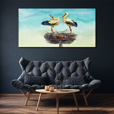 Foto auf leinwand Störche auf einem Nest im Blau