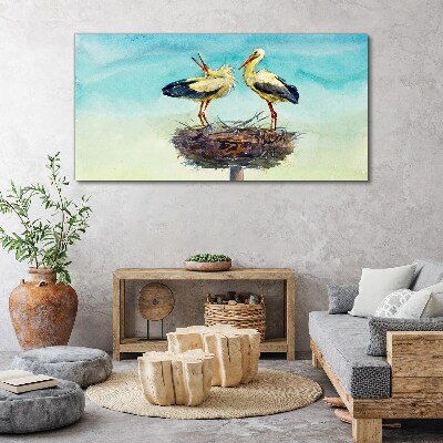 Foto auf leinwand Störche auf einem Nest im Blau