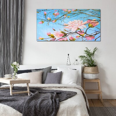 Glasbild Magnolienblüten auf blauem Hintergrund