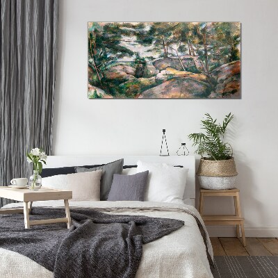 Glasbild Eine steinige Landschaft zwischen Bäumen