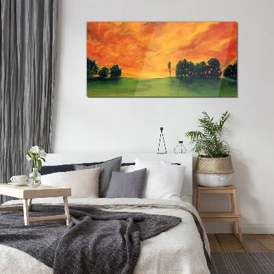 Glasbild Sonnenuntergang über dem grünen Hügel