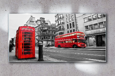 Glasbild Rotes Telefon in einer grauen Stadt