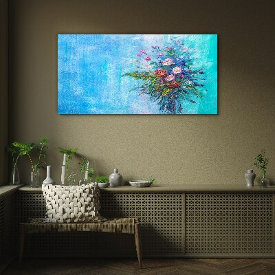 Glasbild Blumenkomposition auf blauem Hintergrund