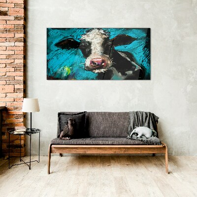 Glasbild Porträt einer Kuh auf blauem Hintergrund