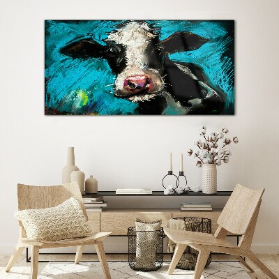 Glasbild Porträt einer Kuh auf blauem Hintergrund