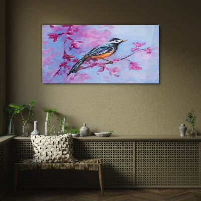 Glasbild Frühlingsvogel auf rosa Zweigen