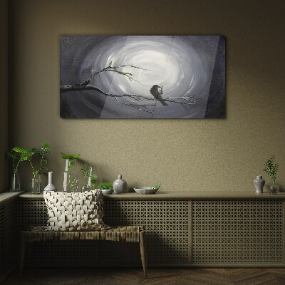 Glasbild Ein einsamer Vogel auf einem Ast