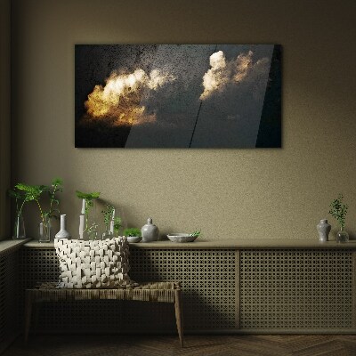 Glasbild Goldene Wolken auf dunklem Hintergrund
