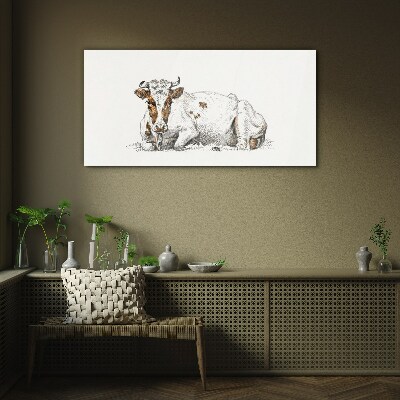 Glasbild Eine ruhige Kuh auf der Wiese