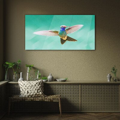 Glasbild Kolibri auf blauem Hintergrund