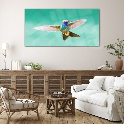 Glasbild Kolibri auf blauem Hintergrund