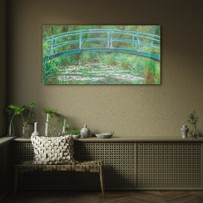 Glasbild Eine Brücke über den Teich