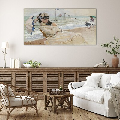 Glasbild Frau am Strand mit einem Sonnenschirm