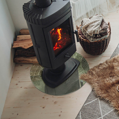 Runde Kamin Glasplatte Tropische Blätter im Hintergrund