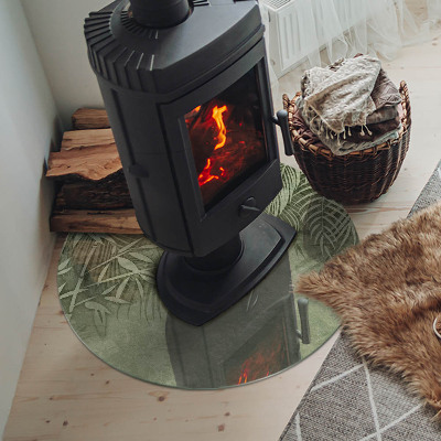 Runde Kamin Glasplatte Tropische Blätter im Hintergrund