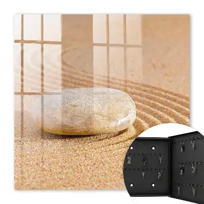 Stein im Sand, sanfte Wellen