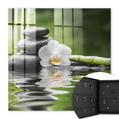 Orchideen-Zen-Steine ​​im Wasser