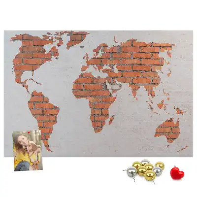 Korktafel mit Weltkarten Motiv auf Ziegelhintergrund